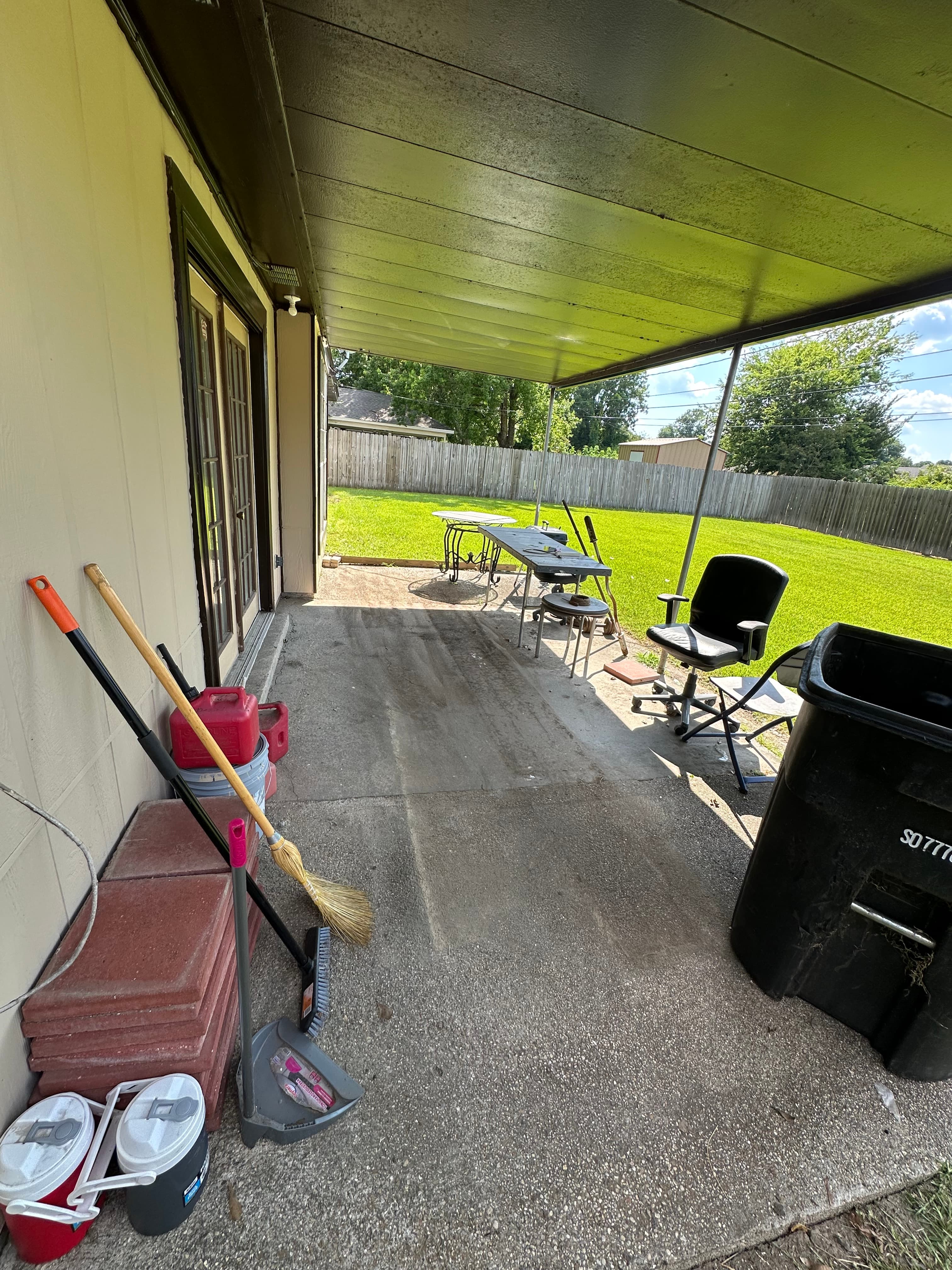 Before and after of a residential patio junk removal project in Baton Rouge, Louisiana. — after